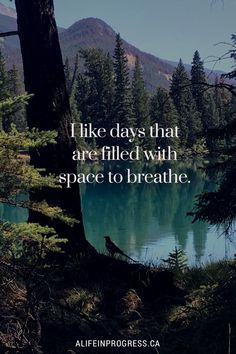 a lake surrounded by trees with a quote on it that says, i like days that are filled with space to breathe