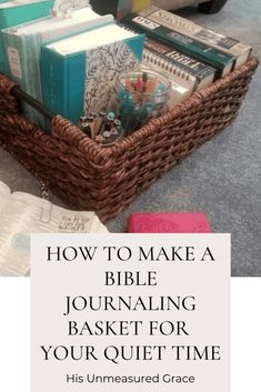 a basket filled with books on the floor next to an open book and some other items