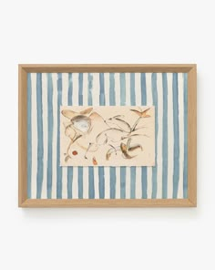 a painting with blue and white stripes on the wall next to a wooden framed object