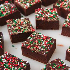 many pieces of chocolate cake with sprinkles on them