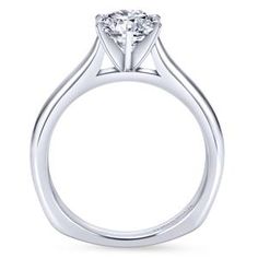 a white gold engagement ring with a round brilliant cut diamond on the center and shoulders