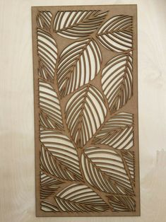 a wooden cutout with leaves on it