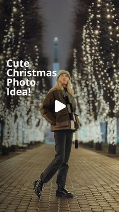 a woman standing in the middle of a street with christmas lights behind her and text that reads cute christmas photo idea