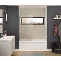 a bathroom with gray walls and white fixtures, including a bathtub in the corner