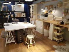 a room filled with lots of different types of furniture and lighting on top of wooden floors