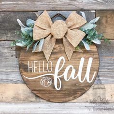 a wooden sign that says hello fall with a bow on it and succulents