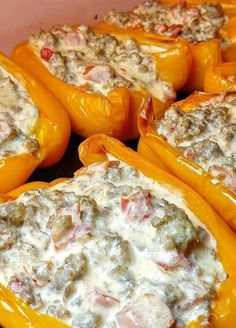 stuffed peppers with meat and cheese in a baking dish