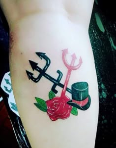 a tattoo with an anchor, rose and hat on it