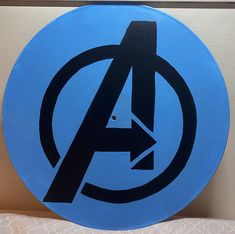 a blue sign with the avengers logo painted on it