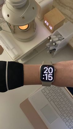 a person wearing an apple watch on their wrist with the time displayed in front of them