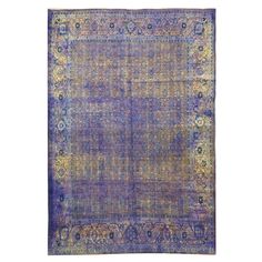 an antique rug with blue and yellow colors