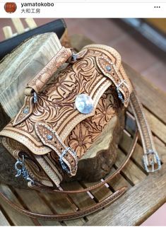 a brown leather purse sitting on top of a wooden table