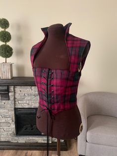 This is the perfect bodice to add to your wardrobe for this years Renaissance and cosplay events! The bodice is a soft, woven wool plaid, in the wine, hunter green, and black Lindsay tartan. The bodice is fully lined, and interlined with 2 layers of canvas, and double-boned at the center fronts. This bodice features a standing collar and the bodice hits mid-bust. The bodices laces closed through 14 black grommets. The bodice measures 36 inches at the bust and 32 inches at the waist, your bust sh Scottish Cosplay, Tartan Wedding Dress Scotland, Scottish Traditional Clothing Women Highland, Tartan Punk, Scottish Costume, Lindsay Tartan, Standing Collar, Irish Celtic, Mini Dresses For Women