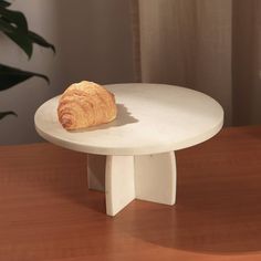 a croissant sitting on top of a white table