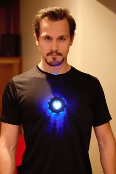 a man wearing a t - shirt with an eyeball on it's chest