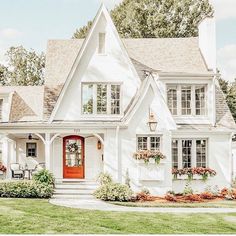 a white house with red door and windows