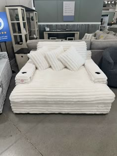 the mattress is on display for sale at the furniture store in an area with sofas and couches