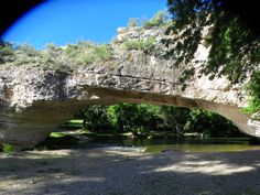 an old stone bridge over a small river