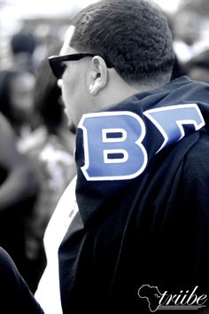 a man in sunglasses and a hoodie with the letters b f on his back