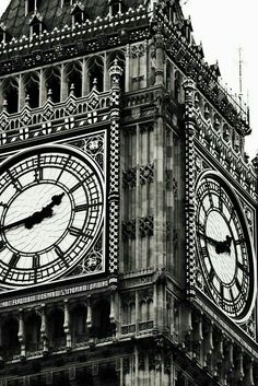 the big ben clock tower towering over the city of london, england in black and white