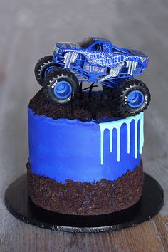 a monster truck cake with blue icing on top