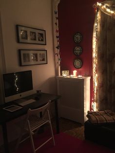 a room with a desk, chair and computer in it