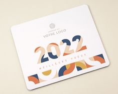 a white business card with an abstract design and the words 2020 written in bold colors