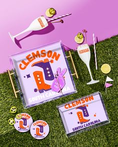 an advertisement for clemson is shown on the grass next to some drinks and golf tees