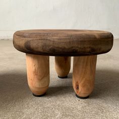 a wooden bench sitting on top of a carpeted floor