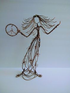 a wire sculpture holding a tennis racket