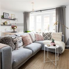 a living room filled with lots of furniture and decor