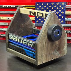 a wooden toy car in front of a pile of skates and american flag wallpaper