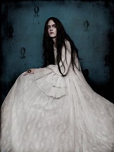 a woman with long hair in a white dress