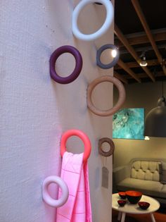 several rings hang on the wall next to a couch