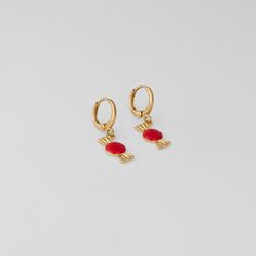 Indulge in the playful charm and vibrant elegance of our Sweet Treat Huggies. These delightful earrings feature a whimsical candy design with rich red accents set against a luxurious gold base, creating a fun and stylish accessory perfect for adding a pop of color to any outfit. Playful Gold Earrings For Party, Red Gold Plated Earrings For Party, Trendy Red Jewelry For Festive Occasions, Trendy Red Festive Jewelry, Sweet Gold Dangle Jewelry, Playful Gold Earrings For Gift, Playful Gold Earrings As A Gift, Playful Gold Earrings, Playful Gold Dangle Earrings