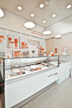 the inside of a deli filled with lots of different types of pastries and desserts