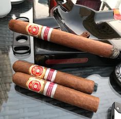 three cigars sitting on top of a table