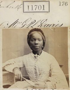 an old photo of a woman sitting in a chair