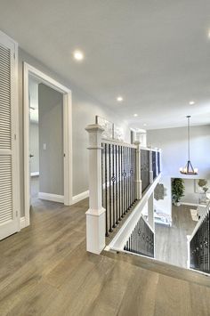 a large open floor plan with stairs and railings