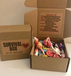 an open survival box filled with candy sits on a table next to a cardboard box