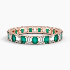 an emerald and white diamond ring in 18k rose gold, set with baguettes