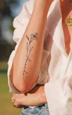 a woman with a flower tattoo on her arm