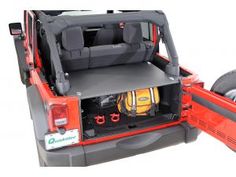 the back end of a jeep with its cargo compartment open and wheels down, on a white background