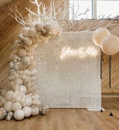 balloons are arranged on the floor in front of a white wall and wooden paneled walls