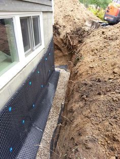 a house that has been gutted and is being worked on by a man with a shovel