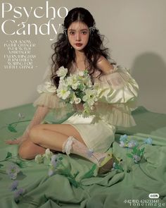 a woman sitting on top of a bed holding a bouquet of flowers