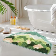 a bathroom with a bathtub and rugs on the floor, next to a sink