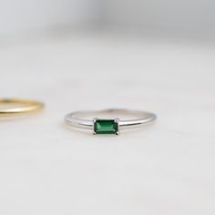 Beautifully crafted emerald ring is a true stunner! Looks great stacked or on its own! Made of 925 Sterling Silver We use a THICK plating of 14k Gold or Rhodium Available in sizes 4-10 3x5mm Baguette Stone Nickel-free & Hypoallergenic - Will not turn your fingers green! Made of the highest grade cubic zirconia for an authentic look! Emerald Baguette Ring, Ring With Green Stone, Layering Diamond Necklaces, Ring Inspo, Minimal Ring, Baguette Ring, Gold Ring Stack, Silver Engagement Rings, Emerald Jewelry