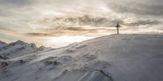 a person standing on top of a snow covered mountain