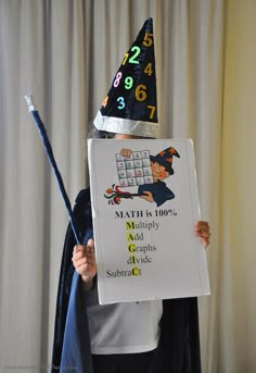 a person in a costume holding up a sign that says math is 100 % and has an odd hat on his head